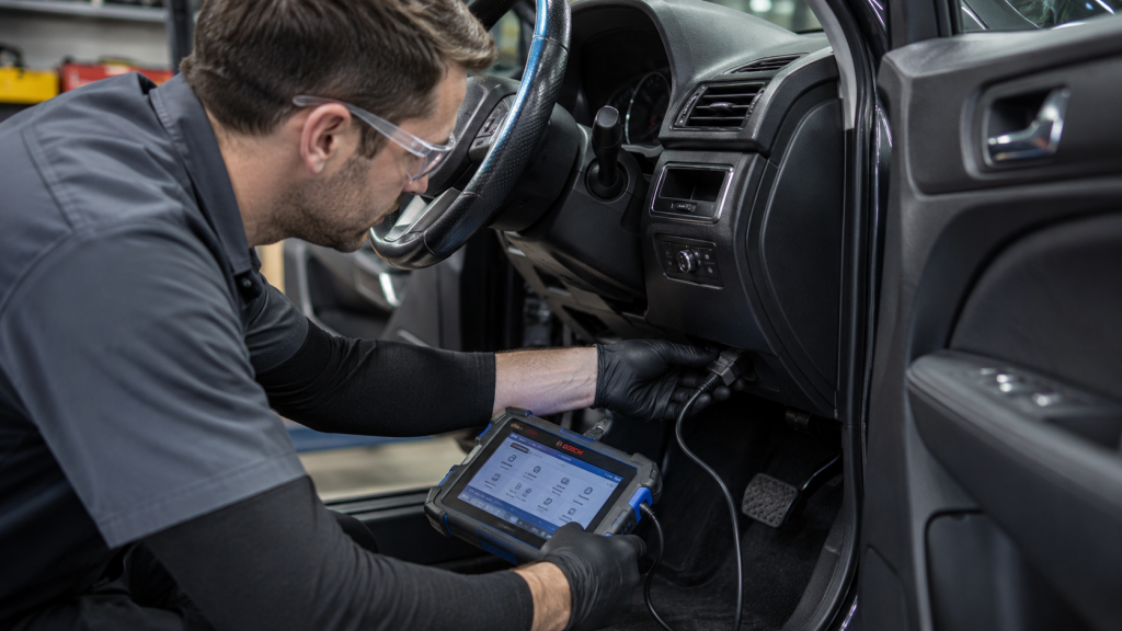 Technician connecting diagnostic tool to vehicle event data recorder